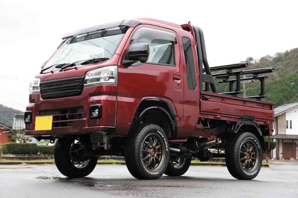 Red Daihatsu Hijet Truck with turbo conversion, lift kit, and roof carrier by Tanto Jidosha