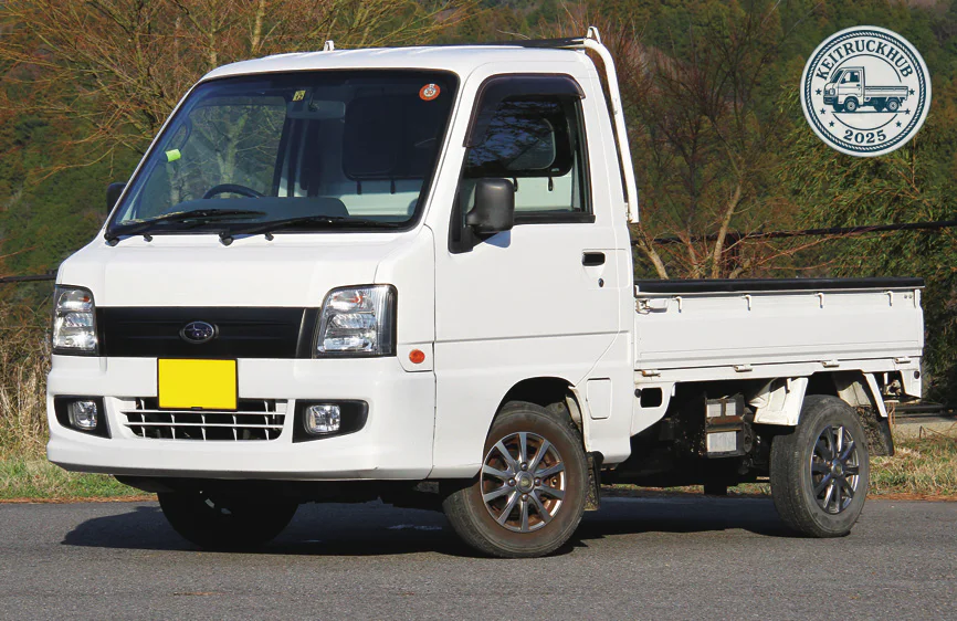 The white Subaru Sambar photographed from the front three-quarter angle outdoors.